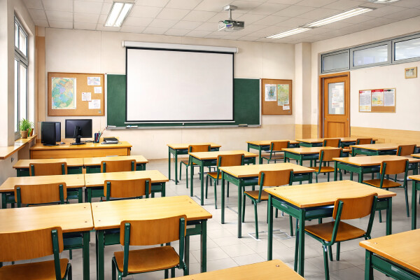 Sala de aula vazia, com as carteiras e cadeiras arrumadas e nenhum professor presente
